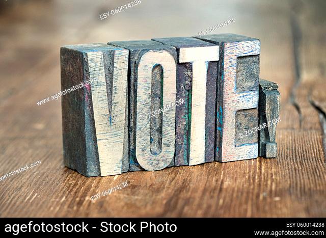 vote exclamation made from wooden letterpress type on grunge wood