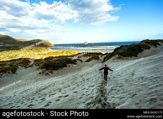 Woman on the way to Sandfly Bay, New Zealand