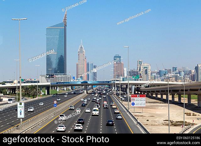 Dubai, United Arab Emirates - October 17, 2014: A wide highway with skyscraper skyline in the background