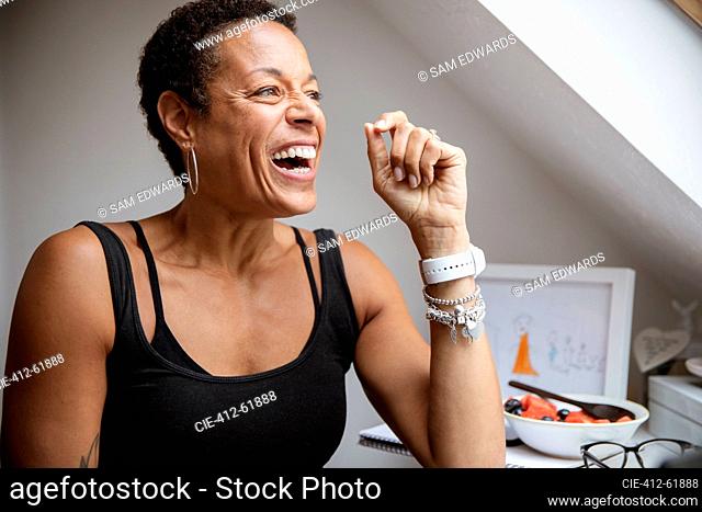 Happy mature woman laughing and looking away