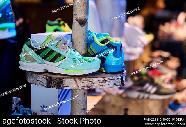 13 November 2022, Berlin: Sneakers in neon colors stand on a log in the Festsaal Kreuzberg. Europe's largest sneakers festival makes its debut in Berlin