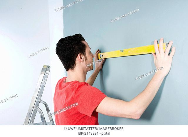Young man using a spirit level