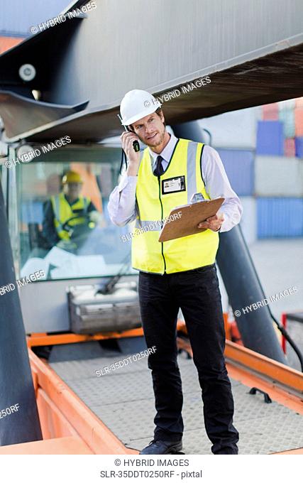 Worker standing on machinery on site