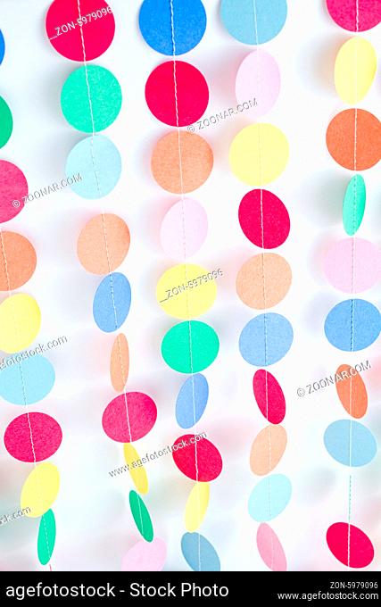 Making a colorful paper garland with reound puncher
