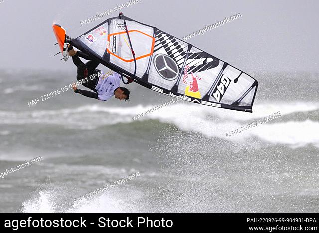 26 September 2022, Schleswig-Holstein, Westerland/Sylt: Philip Köster (Germany) shows a jump in the discipline Wave at the Windsurf World Cup off Sylt