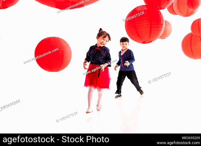 Happy boys and girls playing under the red lanterns