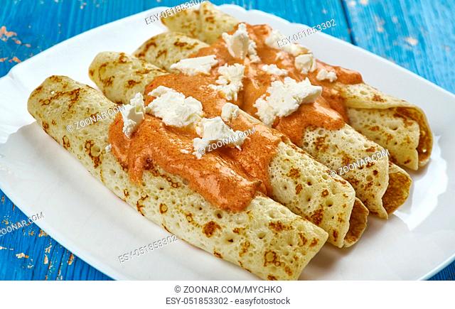 Entomatada typical Mexican dish made of a folded corn tortilla which has first been fried in oil and then bathed in a tomato sauce made from tomatoes, garlic