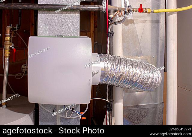 A home humidifier attached to the return duct with a bypass connection to the supply hot air duct
