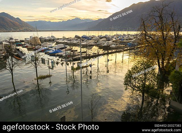 Aerial View over Flooding Street with a Boat in a Port in Locarno, Switzerland
