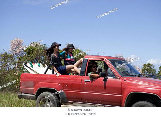 Three young friends driving off road vehicle on vacation