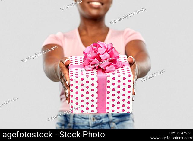 close up of african american woman with gift box