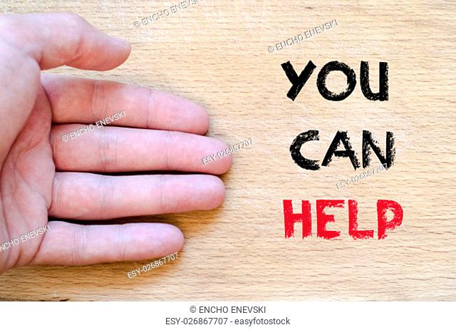 Human hand over wooden background and you can help text concept