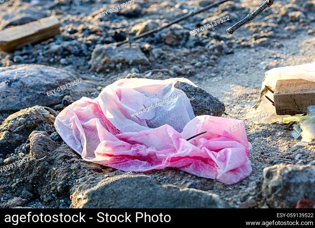 Red plastic found at sea coastal. Environmental pollution