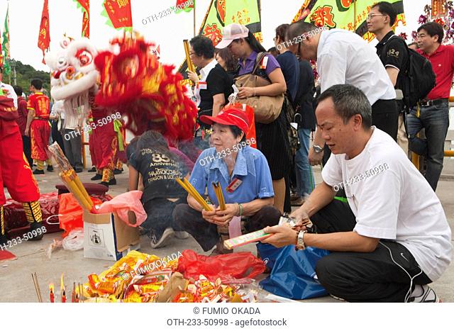 Worshippers offering incense at the Tin Hau temple during the Tin Hau festival, Joss House Bay, Hong Kong