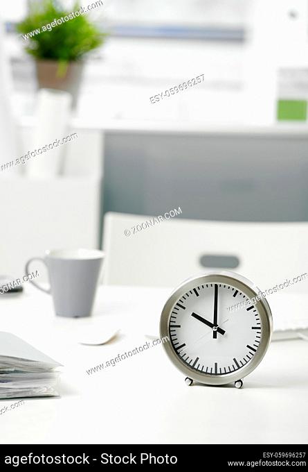 Close-up photo of clock on office desk