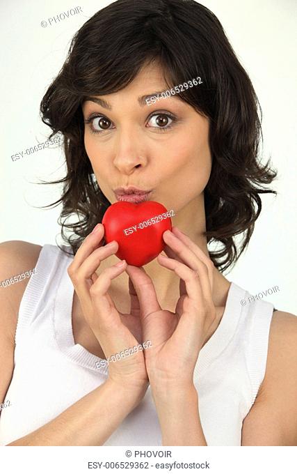 Attractive woman holding a small red heart