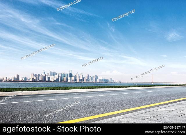 cityscape of hangzhou in blue cloud sky from empty road
