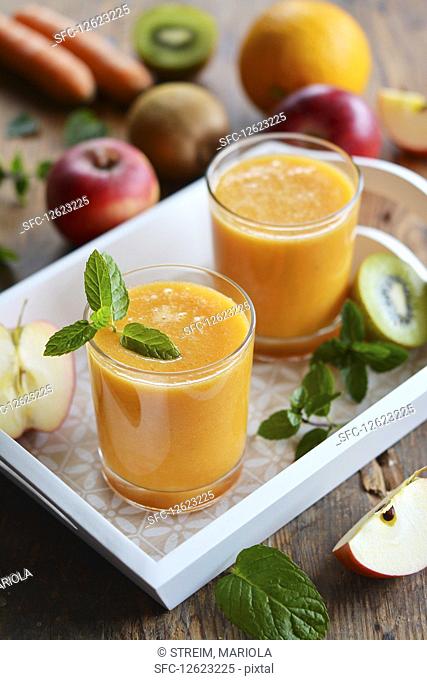 Two glasses of fruit juice on a tray