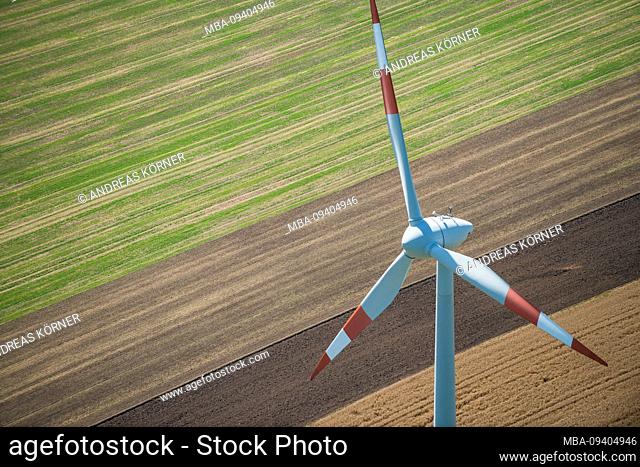 Aerial view of a windmill on agricultural fields and fields