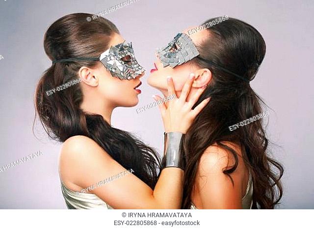 Performance. Fancy Women in Surrealistic Stylized Silver Masks