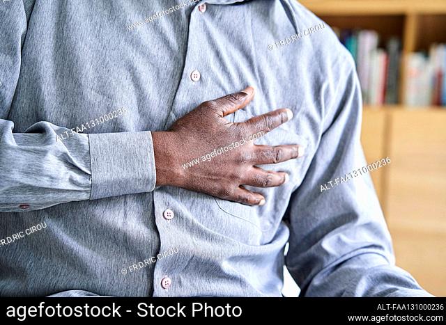 Close-up shot of African-American man with hand on chest