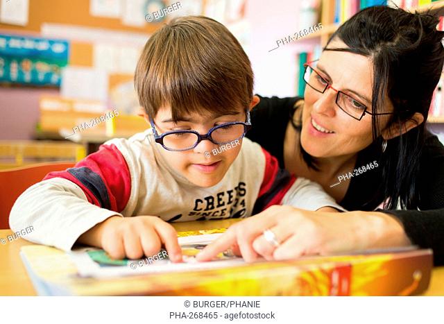 7 years old boy with Down's syndrome and a specialist teacher of first degree educated in an IME Medical-Educational Institute Montmoreau, Charente
