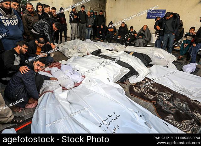 19 December 2023, Palestinian Territories, Rafah: Palestinians bid farewell to their relatives who were killed during Israeli bombardment
