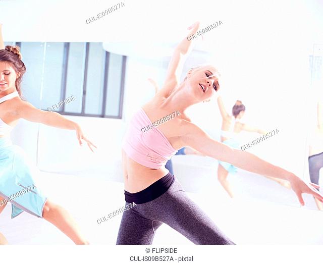 Female ballet dancers practicing, dancing with arms open