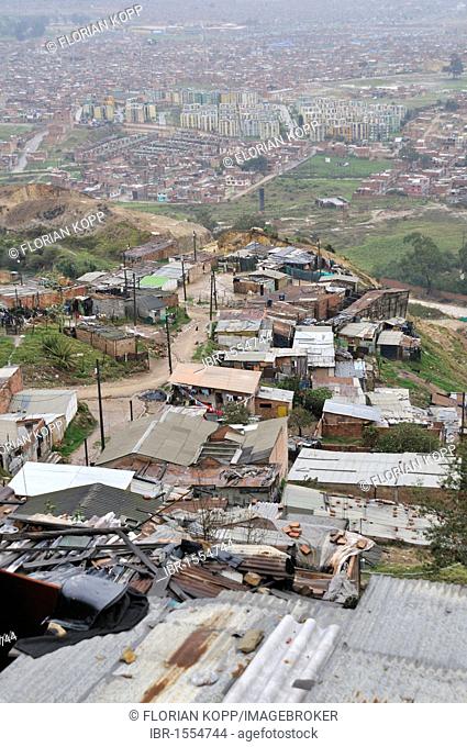 Poor dwellings of civil war refugees and displaced persons in the Altos de la Florida slum. and view of Soacha, Bogota, Cundinamarca, Colombia, South America
