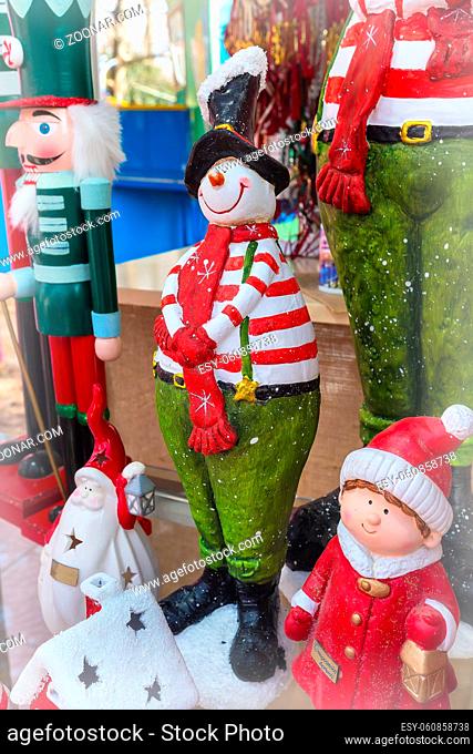 Closeup snowman in red scarf at traditional christmas market