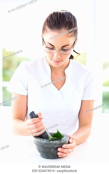 Woman using mortar and pestle