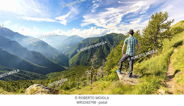 Panoramic of man on Monte Legnoncino with Valvarrone and Valsassina in the background, Lecco province, Lombardy, Italy, Europe