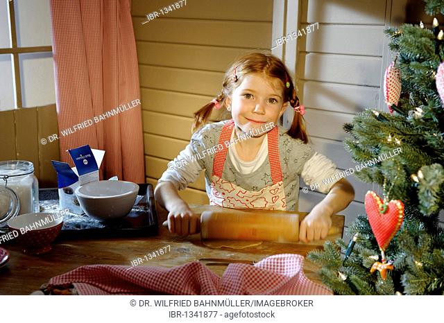 Little girl baking Christmas cookies