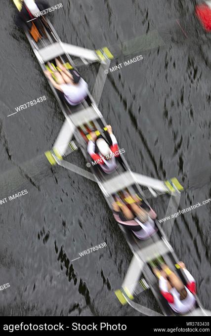 Overhead view of a crew rowing in an octuple racing shell boat, rowers, motion blur