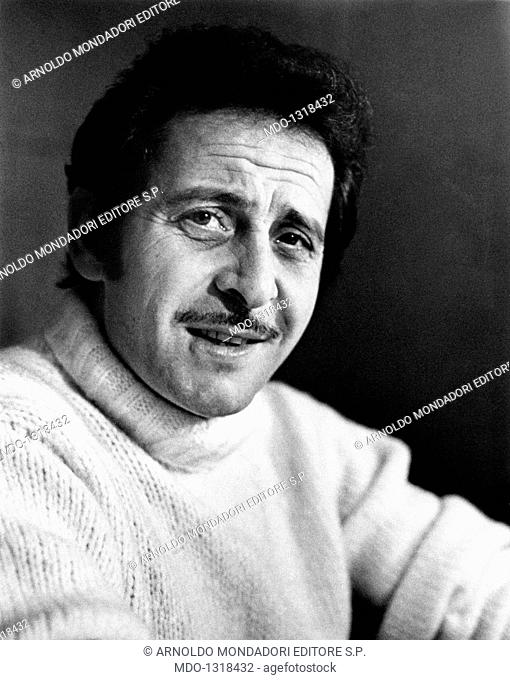An intense close-up of songwriter Domenico Modugno. A portrait of Domenico Modugno while he looks to the objective lens