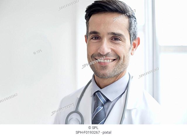 Male doctor smiling towards camera