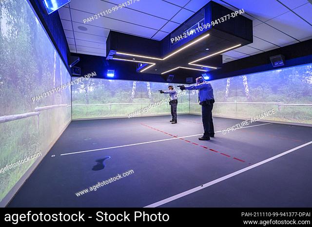 10 November 2021, Saxony, Schneeberg: Two police officers train on the new indoor shooting range of the police training school