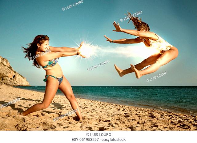 Two girls playing and having fun at the beach
