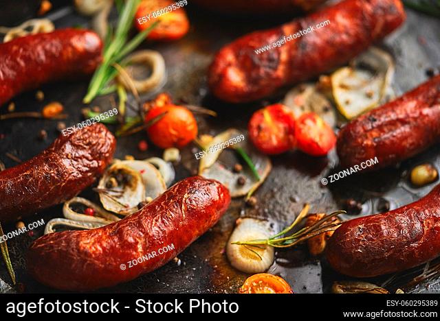 Delicious grilled sausages served on metal rusty tray. With barbecued vegetables, bread and mustard. Top view, flat lay