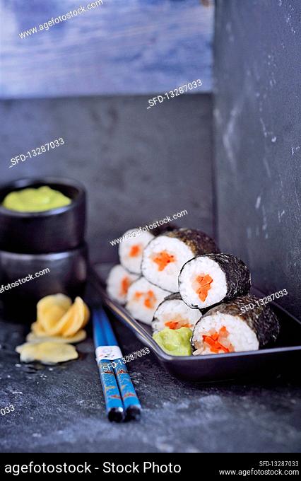 Vegan maki sushi with an avocado and wasabi dip, and gari