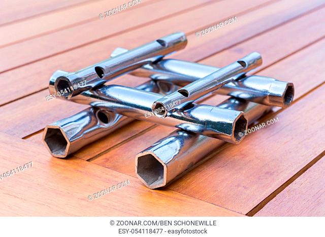 Set of pipe wrenches as built structure on wooden table