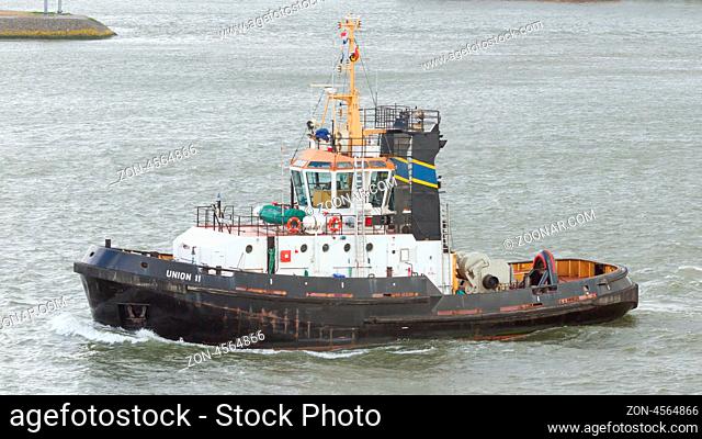 ROTTERDAM, THE NETHERLANDS - JUNE 22: Old tugboat is working in the harbor of Rotterdam (Holland), Rotterdam, June 22, 2012