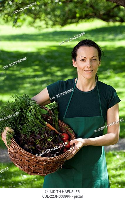 Gardener with vegetables in basket