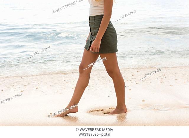Woman walking in the beach on a sunny day