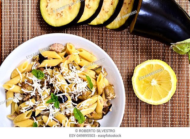 Pasta with eggplant, tuna, mint and ricotta salata. Recipe of Italian cuisine
