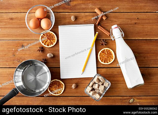 notebook, pencil, ingredients for eggnog cooking