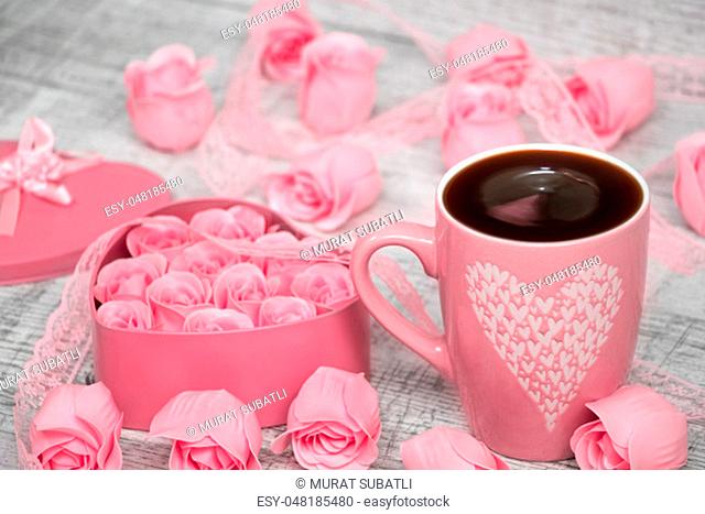 Pink porcelain coffee cup and pink heart roses
