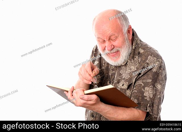 Handsome bald and bearded senior man in yeyeglasses laughing while reading a book, isolated on white background