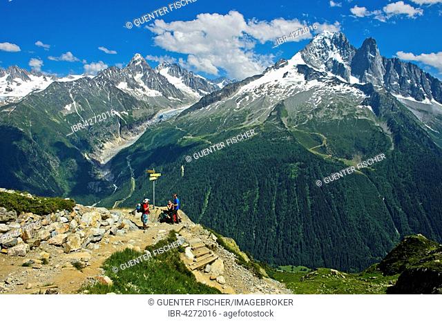 Hikers in the Aiguilles Rouges nature reserve, Aiguille Verte and the Drus on the right, Chamonix, Haute-Savoie department, France