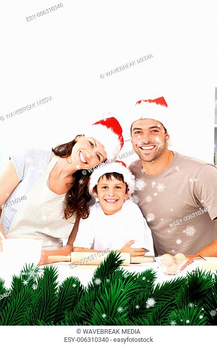 Composite image of happy family baking christmas cookies together